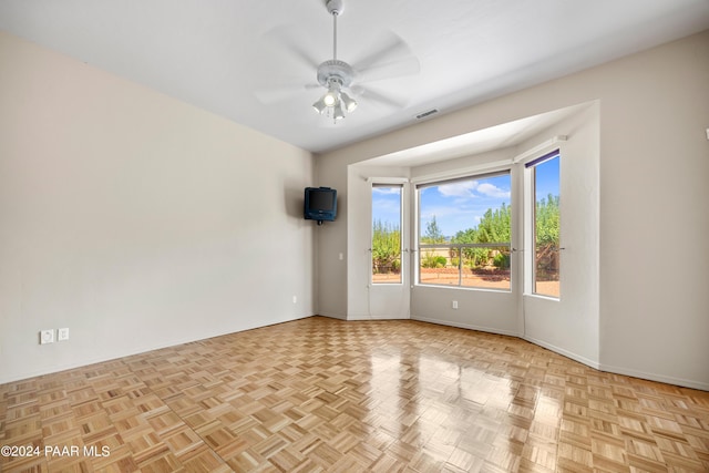 spare room featuring light parquet floors and ceiling fan