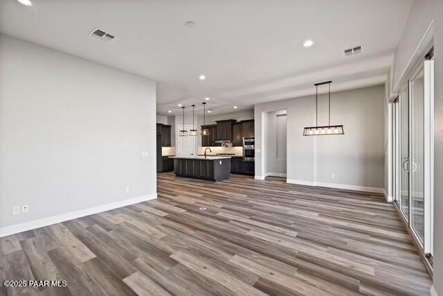 7064 N Robin Nest Ct, Prescott Valley, AZ 86315 - unfurnished living room with recessed lighting and dark wood-style floors
