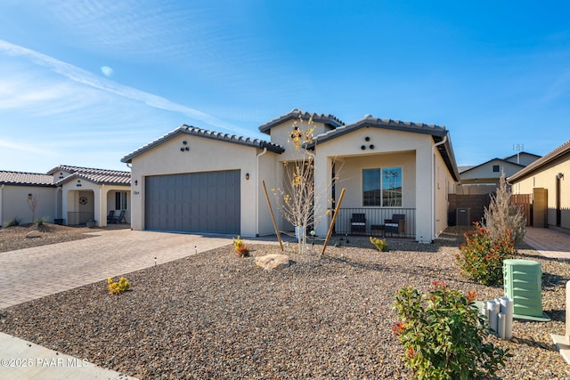 7064 N Robin Nest Ct, Prescott Valley, AZ 86315 - mediterranean / spanish-style house featuring driveway, a garage, stucco siding, and covered porch