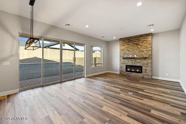 7064 N Robin Nest Ct, Prescott Valley, AZ 86315 - unfurnished living room with wood finished floors, a fireplace, and recessed lighting
