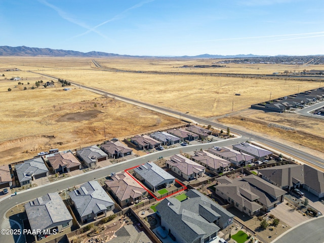 7064 N Robin Nest Ct, Prescott Valley, AZ 86315 - aerial view of sparsely populated area with a mountain backdrop, nearby suburban area, and property boundaries highlighted