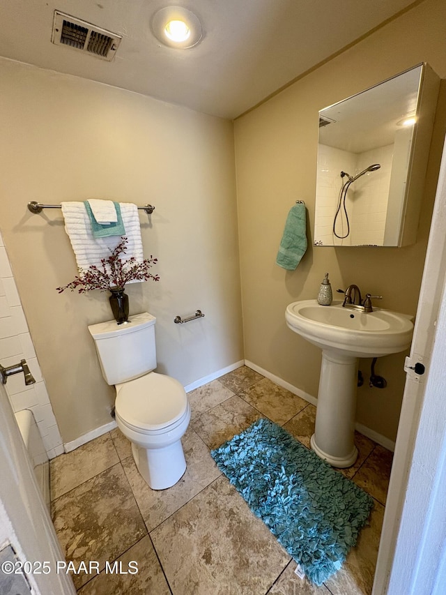 full bathroom featuring toilet, visible vents, tile patterned flooring, and a shower