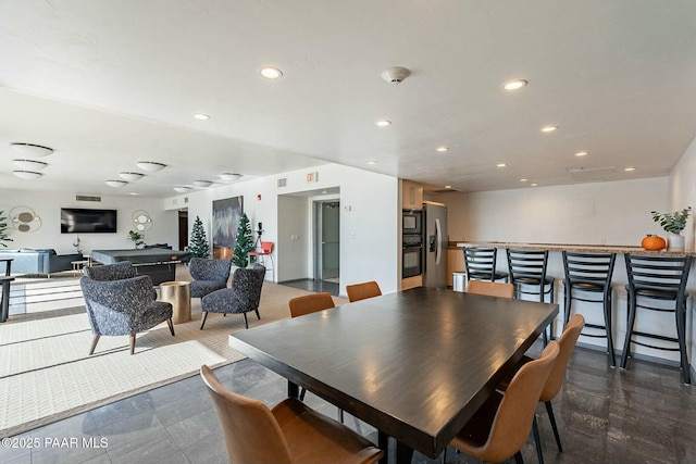 dining room featuring a community bar, visible vents, and recessed lighting