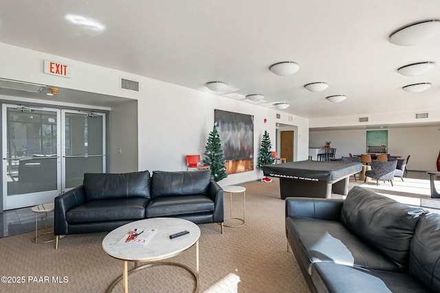 carpeted living area featuring visible vents
