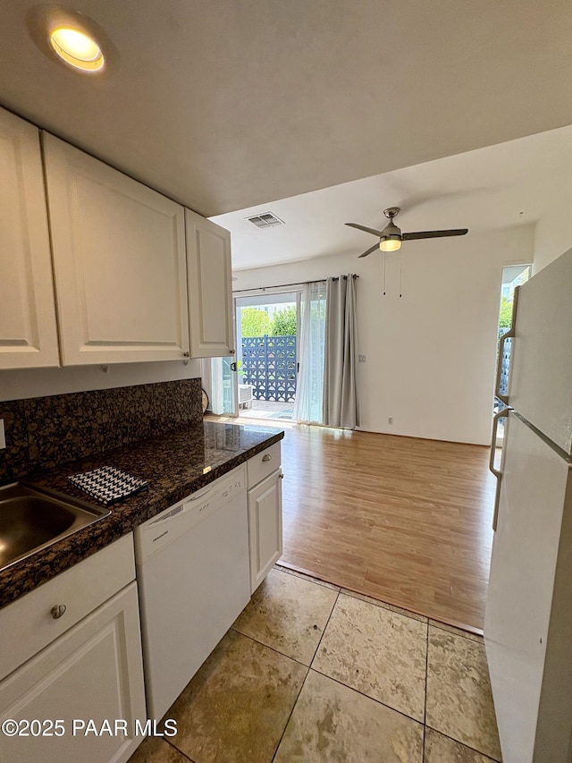 kitchen with a ceiling fan, light tile patterned floors, white appliances, a sink, and white cabinets