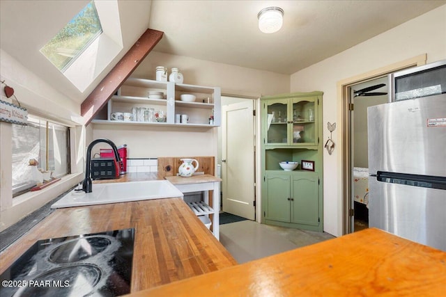 2308 W Mountain Laurel Rd, Prescott, AZ 86303 - kitchen with open shelves, freestanding refrigerator, a sink, black electric stovetop, and butcher block counters