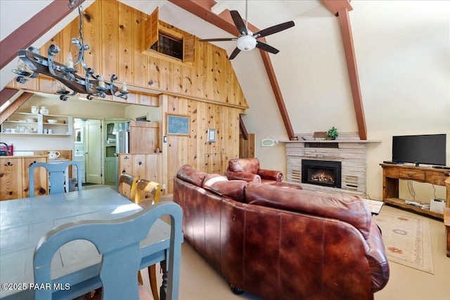 2308 W Mountain Laurel Rd, Prescott, AZ 86303 - living room featuring wooden walls, high vaulted ceiling, a fireplace, ceiling fan, and beamed ceiling