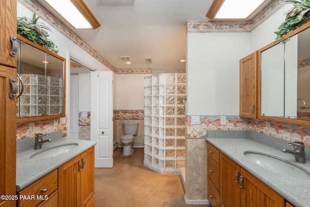 14705 E State Route 169, Dewey-Humboldt, AZ 86327 - full bathroom with a wainscoted wall, two vanities, toilet, tiled shower, and a baseboard heating unit