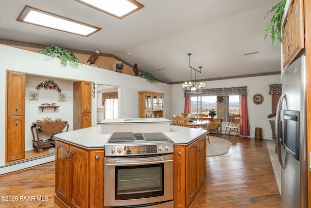14705 E State Route 169, Dewey-Humboldt, AZ 86327 - kitchen with appliances with stainless steel finishes, a kitchen island, brown cabinetry, dark wood-style flooring, and vaulted ceiling