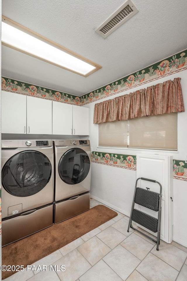 14705 E State Route 169, Dewey-Humboldt, AZ 86327 - washroom with cabinet space, washing machine and clothes dryer, light tile patterned flooring, and a textured ceiling