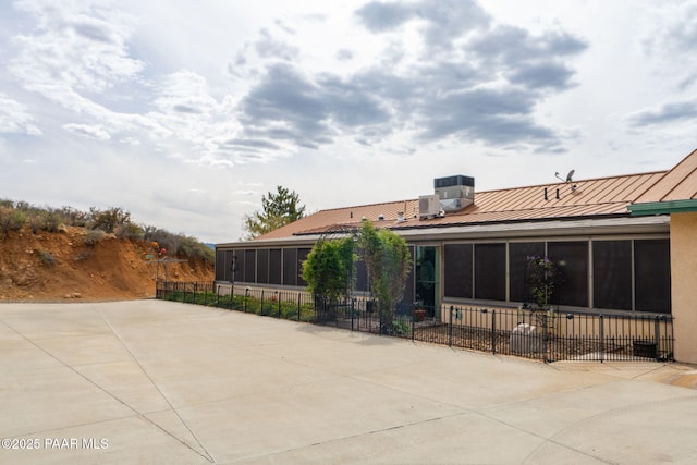 14705 E State Route 169, Dewey-Humboldt, AZ 86327 - rear view of property featuring a sunroom, fence, metal roof, a standing seam roof, and central AC unit