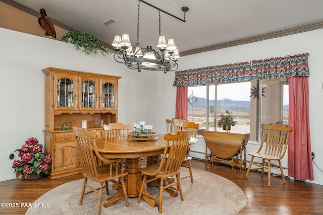 14705 E State Route 169, Dewey-Humboldt, AZ 86327 - dining room with a chandelier, a mountain view, healthy amount of natural light, wood finished floors, and crown molding