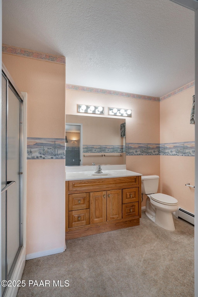 14705 E State Route 169, Dewey-Humboldt, AZ 86327 - bathroom featuring a baseboard heating unit, a shower with shower door, vanity, toilet, and a textured ceiling