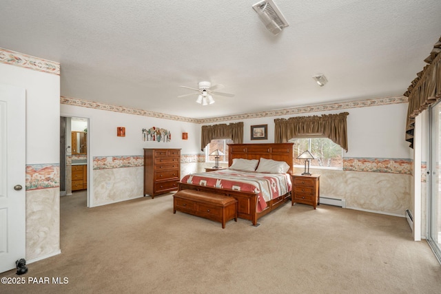 14705 E State Route 169, Dewey-Humboldt, AZ 86327 - bedroom featuring wallpapered walls, light carpet, a textured ceiling, a baseboard heating unit, and a wainscoted wall