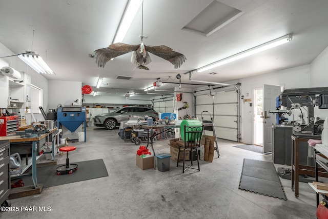 14705 E State Route 169, Dewey-Humboldt, AZ 86327 - garage featuring a workshop area and a garage door opener