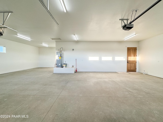 garage with a garage door opener and water heater