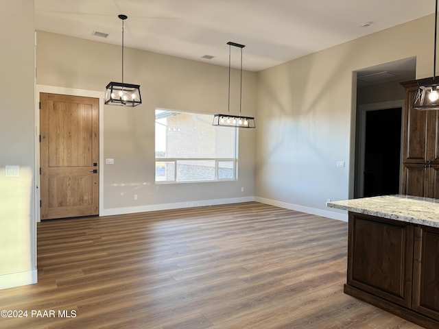 unfurnished dining area with wood-type flooring