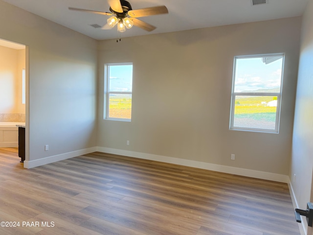 spare room featuring hardwood / wood-style floors and ceiling fan