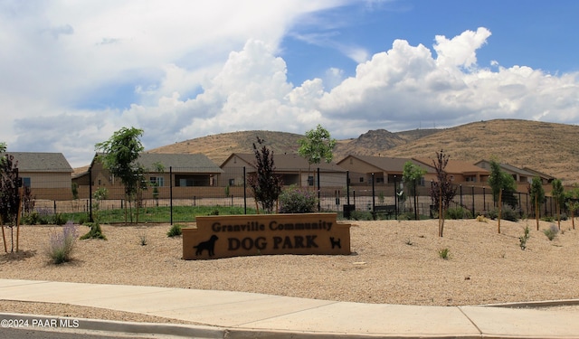 exterior space featuring a residential view, fence, and a mountain view