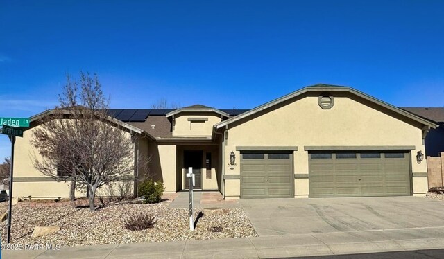 view of front of house with solar panels and a garage