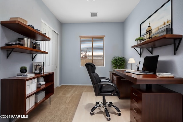 home office featuring baseboards, visible vents, and light colored carpet