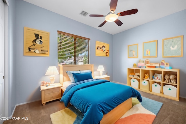 bedroom with visible vents, dark carpet, baseboards, and ceiling fan