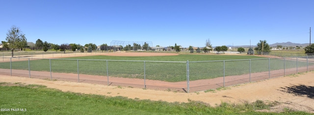 surrounding community with a rural view and fence