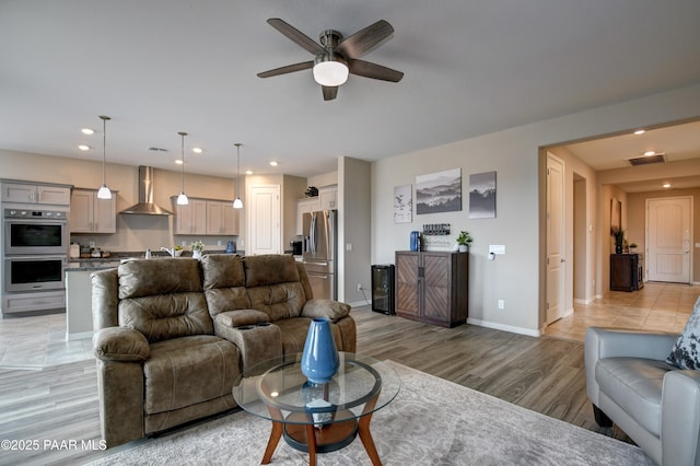 living room featuring visible vents, recessed lighting, baseboards, and light wood-style floors