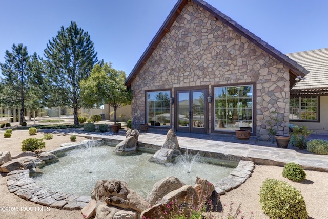 rear view of property with a patio, a tile roof, and fence