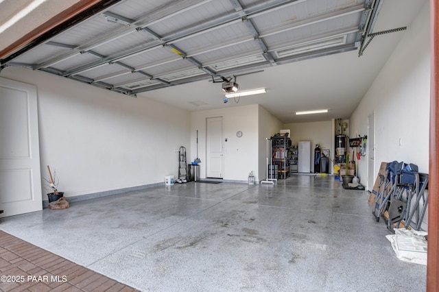 garage featuring a garage door opener and water heater