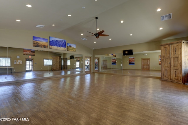 exercise room with visible vents, a healthy amount of sunlight, and wood finished floors