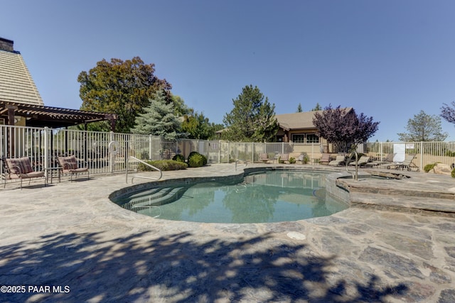 pool with a patio and fence