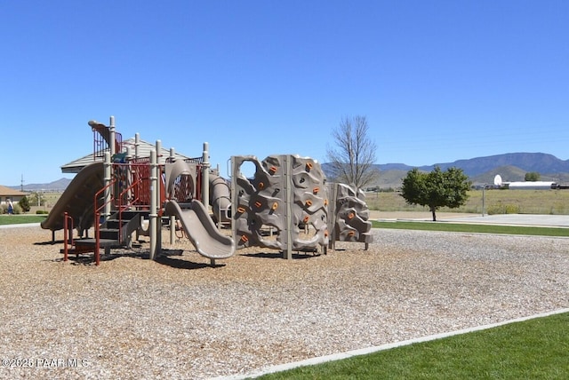 community jungle gym featuring a mountain view