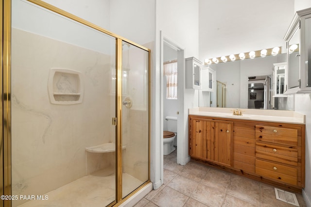 full bathroom featuring vanity, toilet, tile patterned floors, a stall shower, and visible vents