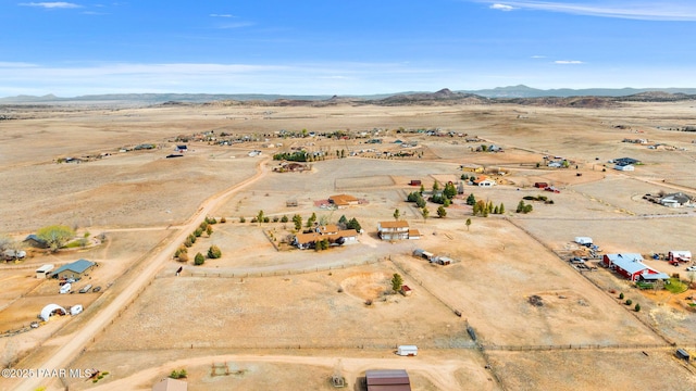 drone / aerial view with a mountain view, a rural view, and view of desert