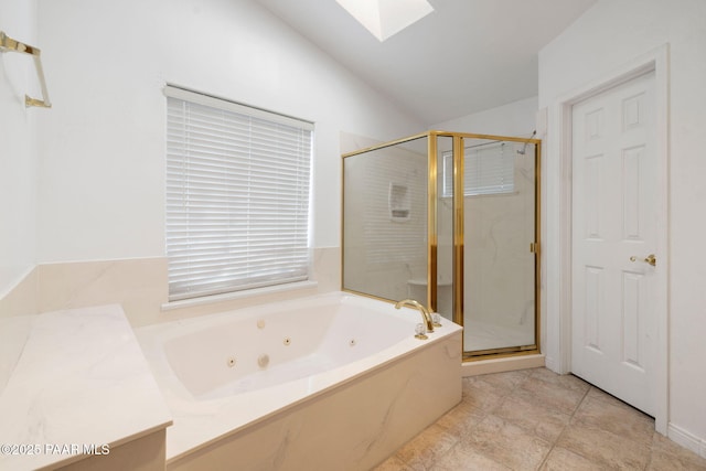 full bathroom with vaulted ceiling with skylight, a jetted tub, and a marble finish shower