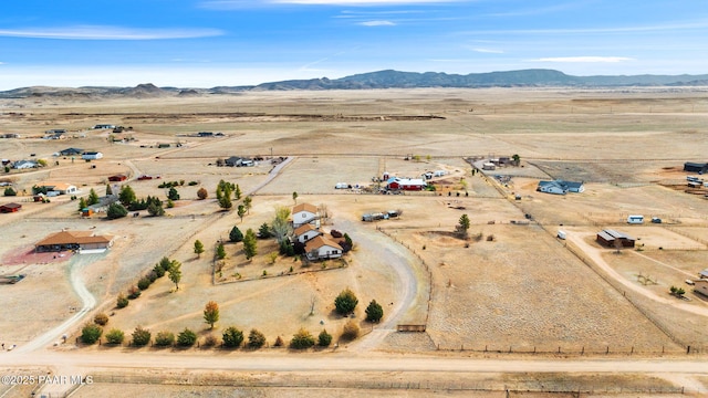 birds eye view of property with view of desert, a mountain view, and a rural view