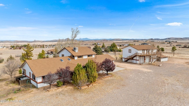 birds eye view of property featuring a mountain view