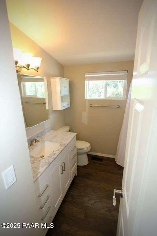 487 Stewart Cir, Prescott, AZ 86301 - bathroom with vanity, toilet, wood finished floors, and baseboards