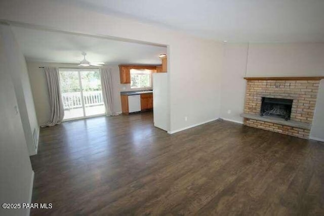 487 Stewart Cir, Prescott, AZ 86301 - unfurnished living room with dark wood-style flooring, a fireplace, ceiling fan, and baseboards
