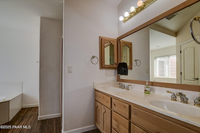 9100 E Lonesome Valley Rd, Prescott Valley, AZ 86315 - bathroom featuring double vanity, baseboards, a sink, and wood finished floors
