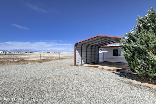 9100 E Lonesome Valley Rd, Prescott Valley, AZ 86315 - view of outbuilding with a detached carport, driveway, and fence