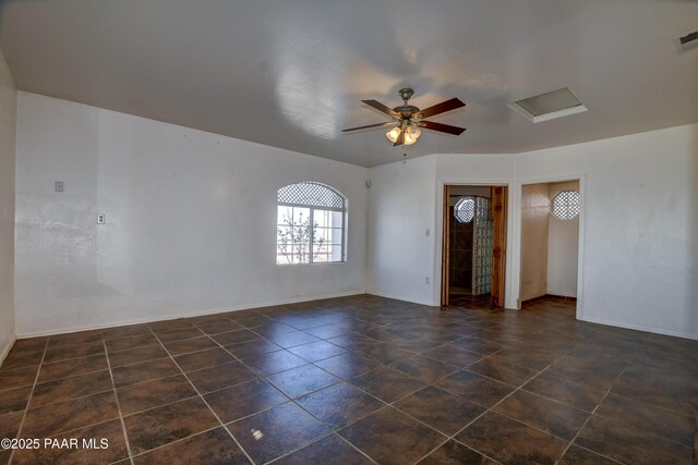9100 E Lonesome Valley Rd, Prescott Valley, AZ 86315 - unfurnished room featuring visible vents, baseboards, a ceiling fan, and dark tile patterned flooring