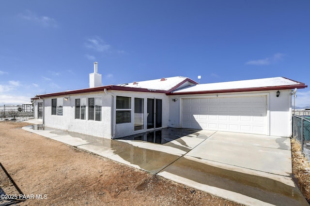 9100 E Lonesome Valley Rd, Prescott Valley, AZ 86315 - exterior space featuring stucco siding, fence, an attached garage, a chimney, and concrete driveway