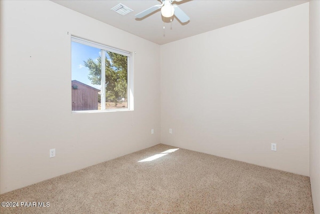 carpeted spare room with ceiling fan