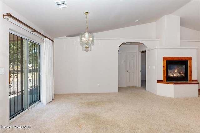 interior space with lofted ceiling, light carpet, and an inviting chandelier