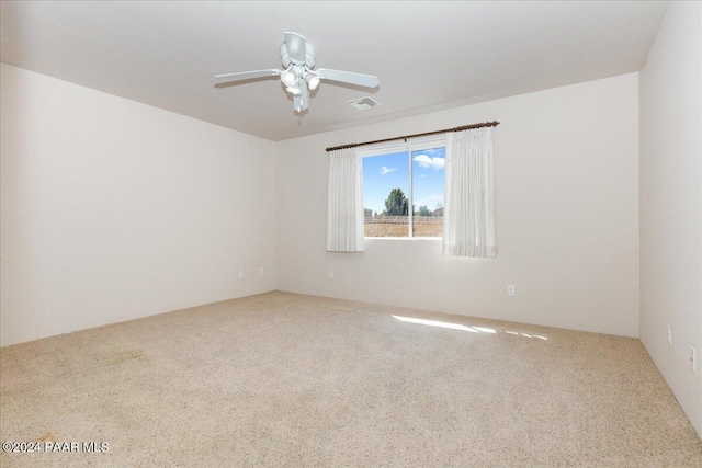 spare room with ceiling fan and carpet floors