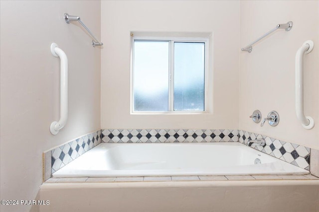 bathroom featuring tiled tub