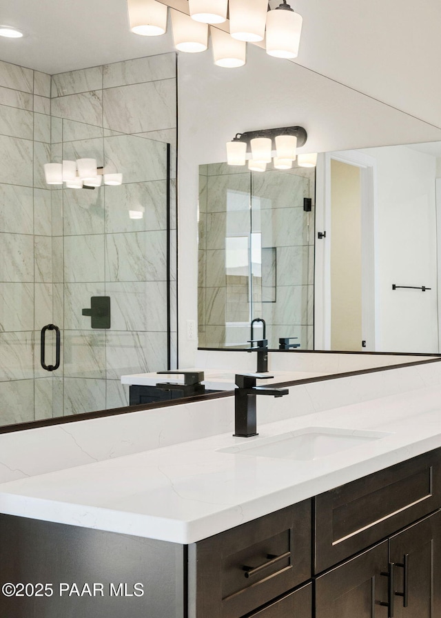 bathroom with vanity and a shower with door