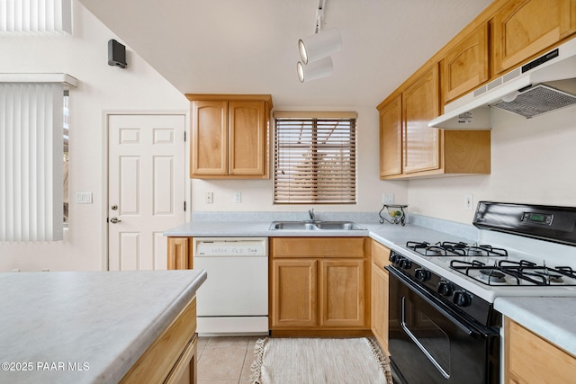 kitchen featuring range with gas stovetop, a sink, light countertops, under cabinet range hood, and dishwasher